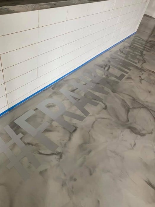 Franklin Sports swirl epoxy flooring with text in Stoughton, MA.