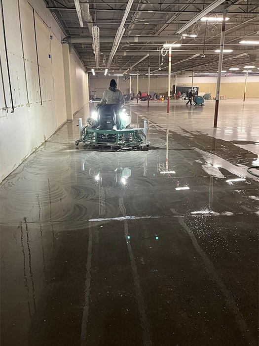 Man using concrete polishing equipment designed for very large spaces.